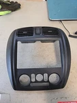 2000 Mazda Protege Dash / Radio Heater Bezel Black 55211. Fixed Price $66.50.